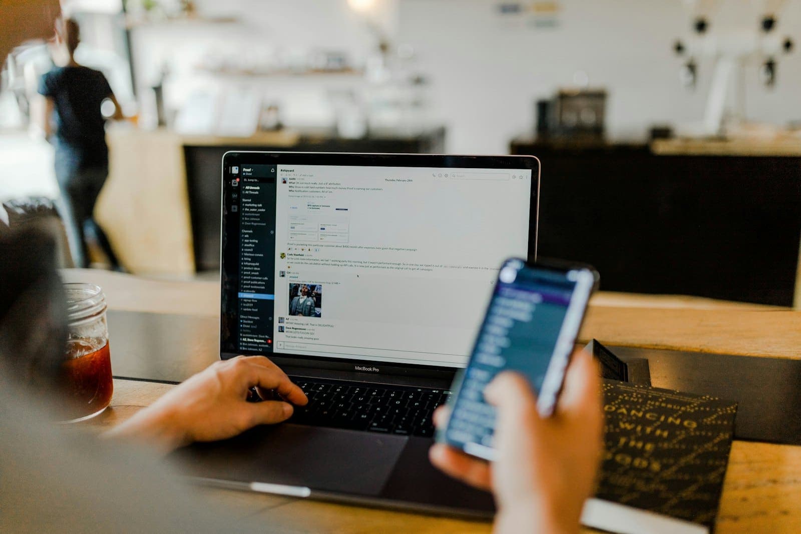 Customer using a smartphone and laptop for digital banking