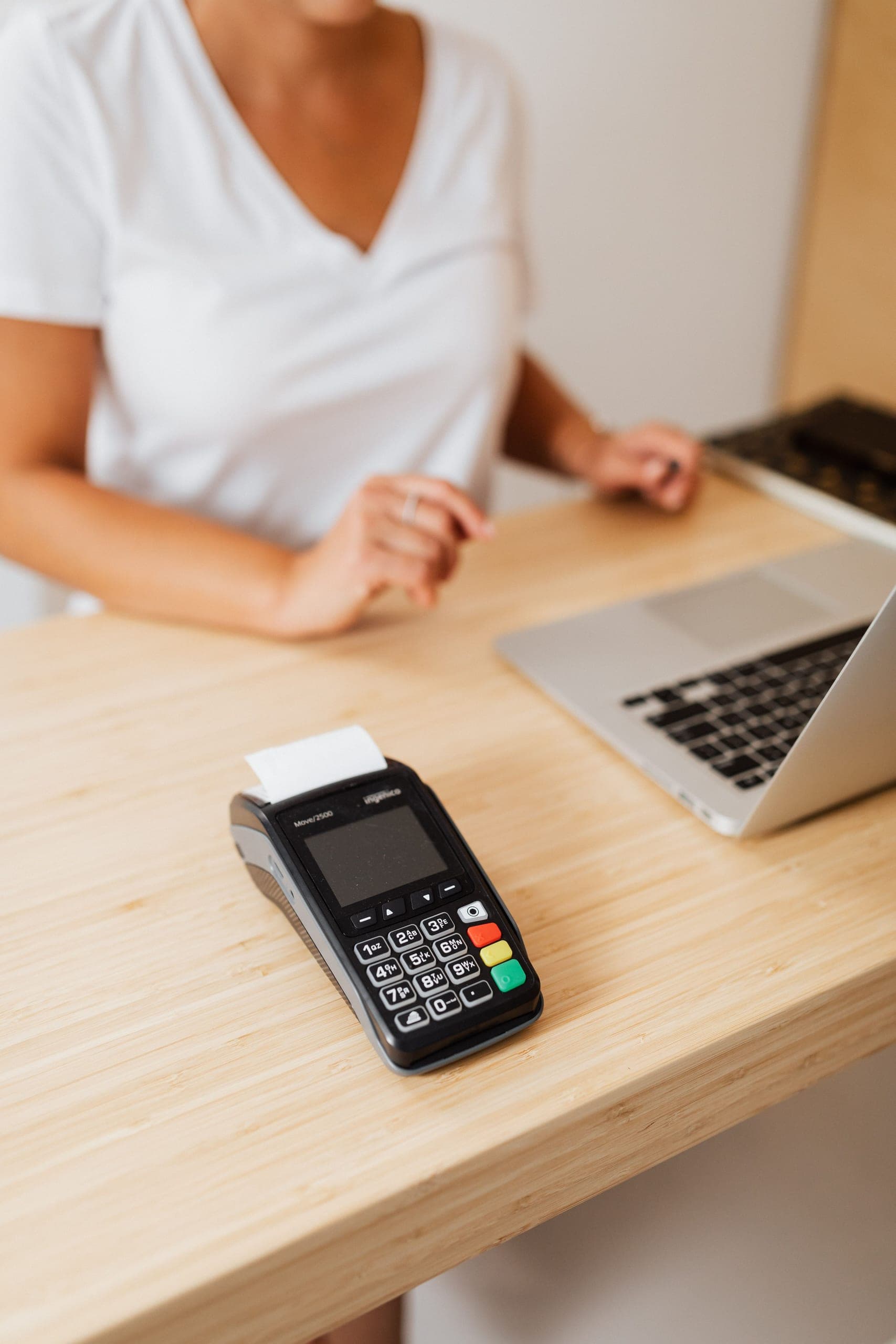 Customer paying with a smartphone at a shop counter